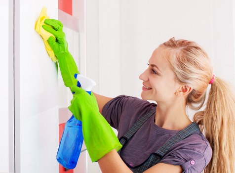 Office cleaner maintaining a tidy workspace in Enfield